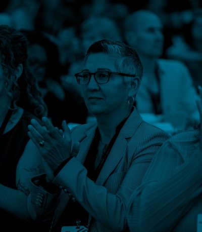 Members of the Satterberg Foundation are the in the middle of clapping for a conference presenter.