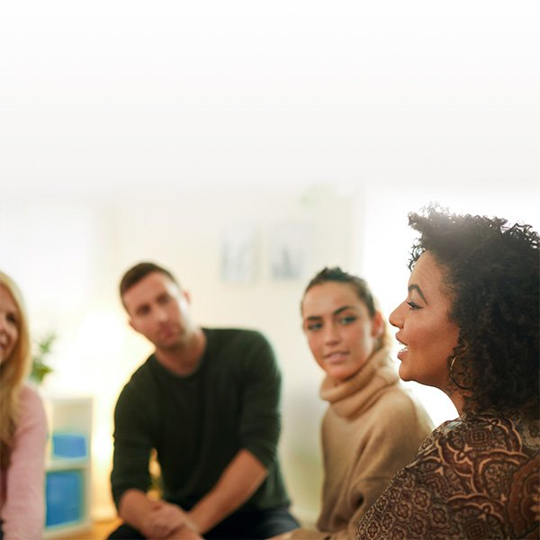 A group of three colleagues talking with each other