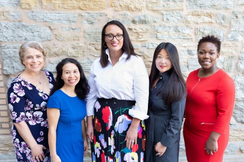 Five women of the McKnight leadership team stand for a group photo
