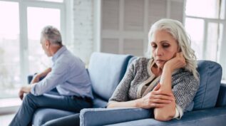 man and woman on couch facing away from each other