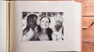 Mothers day composition. Photo album, black-and-white picture. Studio shot on wooden background.