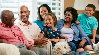 Photo of an African American family sitting on a couch in a living room