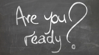 There's a blackboard with "are you ready?" written on it in white writing