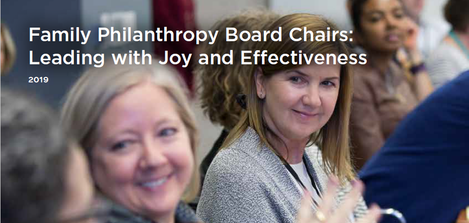 Two white women sit at a table, looking off camera to illustrate the Passages issue brief on Board Chairs