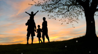 family silhouette at sunset