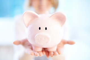 Image of pink piggy bank on human palms