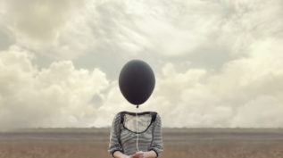 woman's head replaced by a black balloon