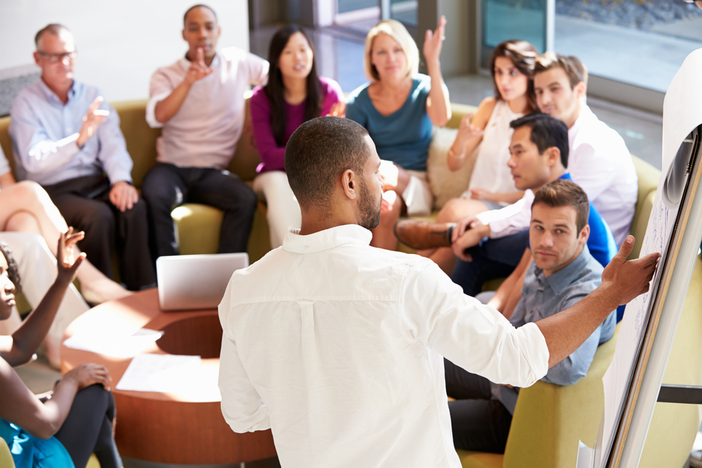 boardroom meeting with a large group of people