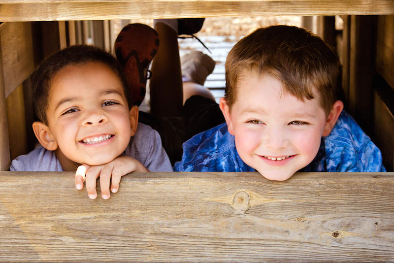 two young children smile at the camera