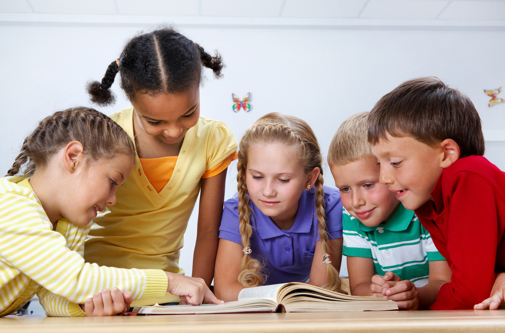 a group of children reads together