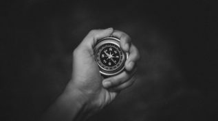 hand holding compass