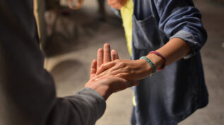 hands reaching out to each other, helping