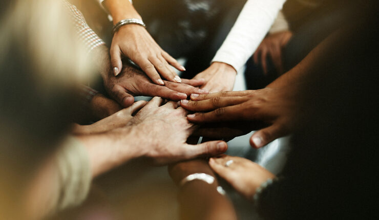 multiracial hands stacked on top of one another