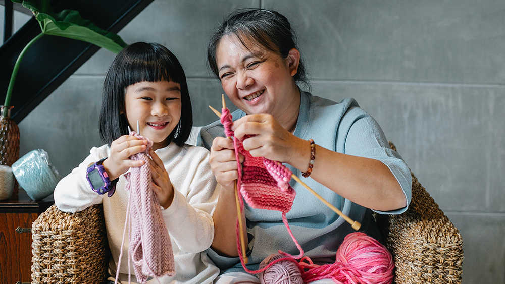 young child and grandmother knitting - engaging the next generation