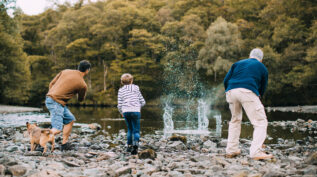 father, son, and grandfather skipping stones - traditions, generations, family cutlure