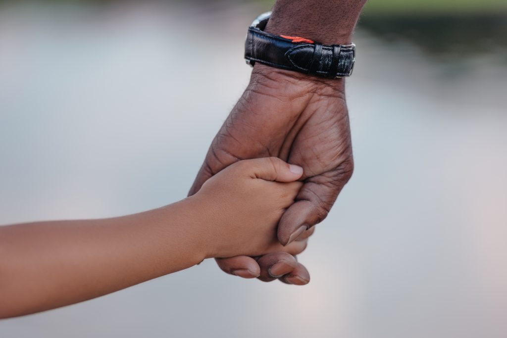 Adult hand holding child's hand - legacy