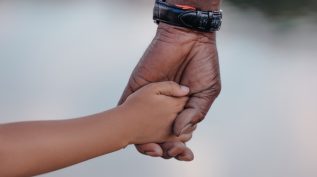 Adult hand holding child's hand - legacy