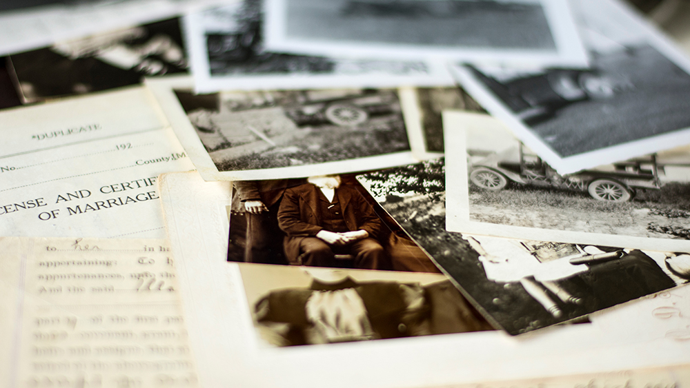 old photographs on table; genealogy; family tree