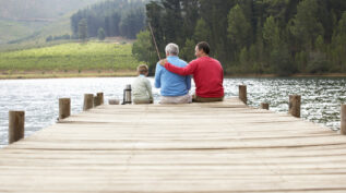 father, son, and grandfather fishing off a pier