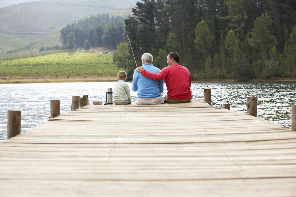 father, son, and grandfather fishing off a pier