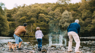 A family working together on family philanthropy while skipping stones