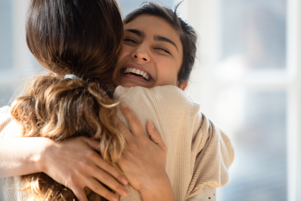 Two women hugging. Conflict repair