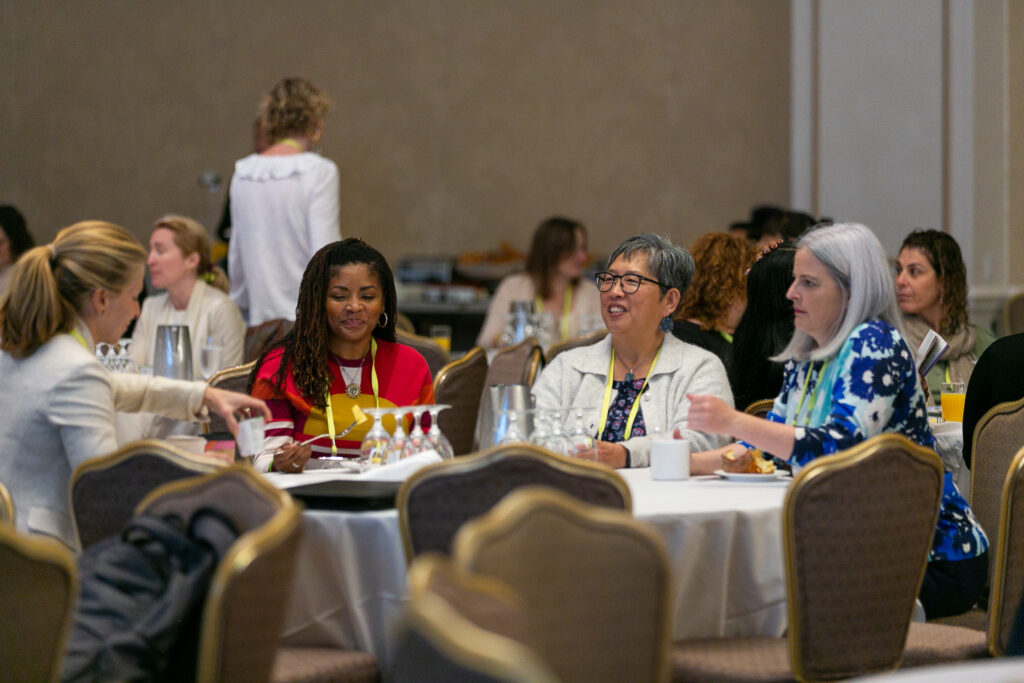Attendees sitting at a table at an NCFP event