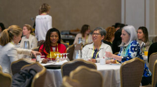 Attendees sitting at a table at an NCFP event